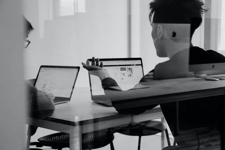 Person using a laptop, photographed in profile