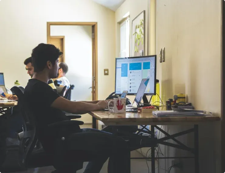 Founders discussing a startup idea around a laptop