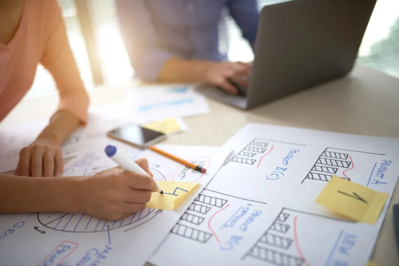 People preparing diagrams for a project presentation