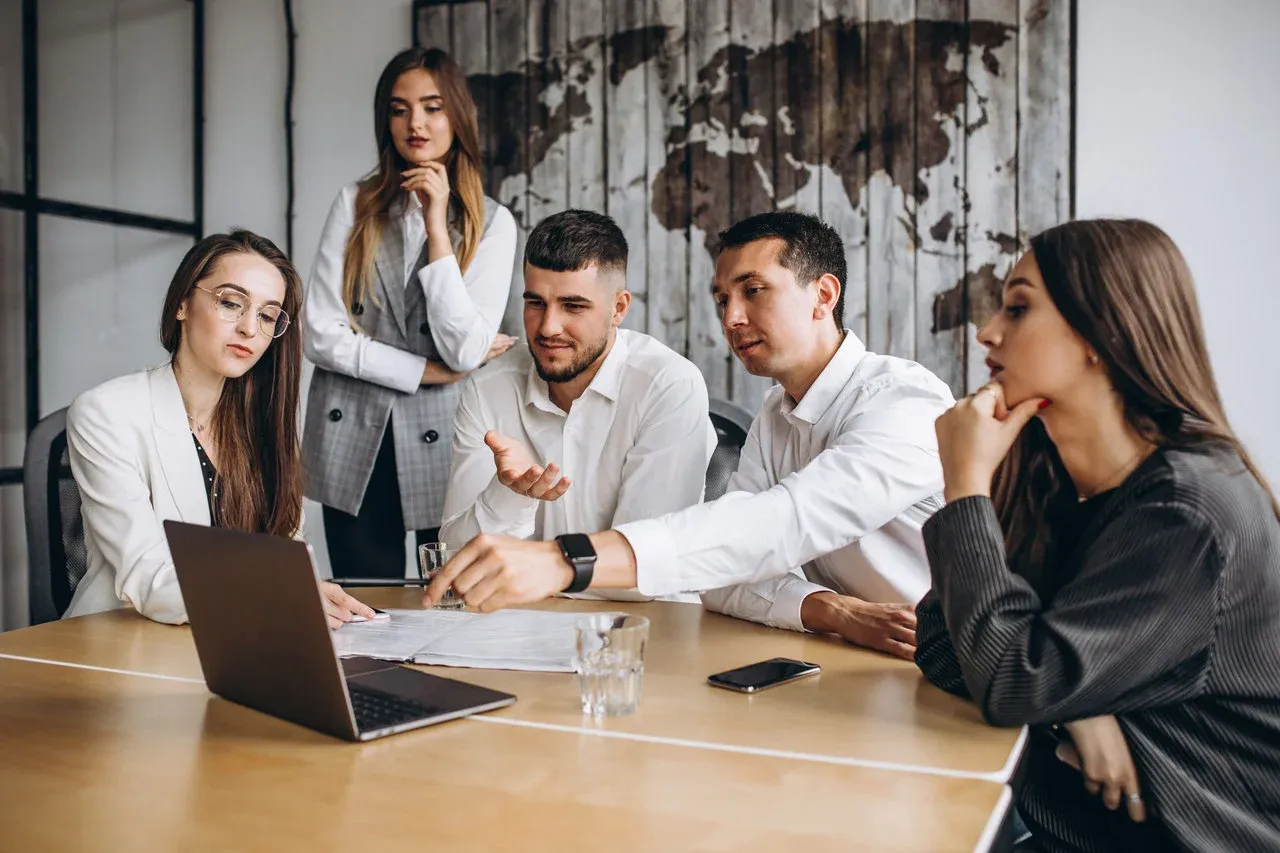Group working through a business plan in an office